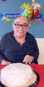 Birthday boy celebrating with cake in nursing home covid-style quarantine